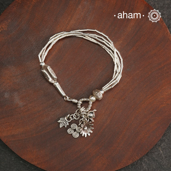 Up your wrist game with the A.M P.M Silver bracelet! Beautiful distinct charms all crafted in 92.5 silver come together to make this piece. Whether worn at day or night, this bracelet is perfect for adding a playful touch to any outfit.The price is for one piece only.