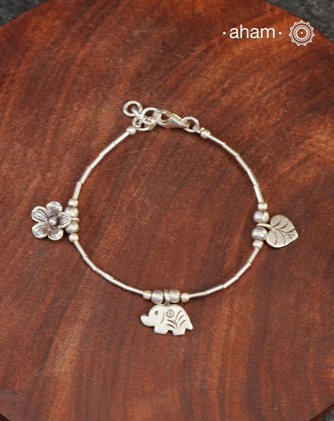 Up your wrist game with the A.M P.M Silver bracelet!
beautiful distinct charms all crafted in 92.5 silver come together to make this piece . Whether worn at day or night, this bracelet is Perfect for adding a playful touch to any outfit.