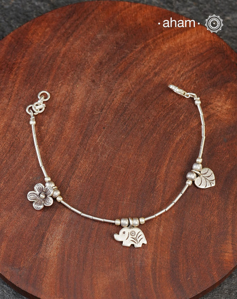 Up your wrist game with the A.M P.M Silver bracelet!
beautiful distinct charms all crafted in 92.5 silver come together to make this piece . Whether worn at day or night, this bracelet is Perfect for adding a playful touch to any outfit.