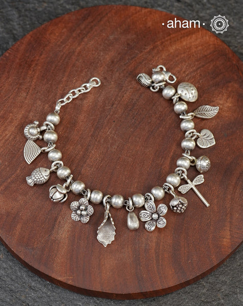 Up your wrist game with the A.M P.M Silver bracelet!
15 beautiful distinct charms all crafted in 92.5 silver come together to make this piece . Whether worn at day or night, this bracelet is Perfect for adding a playful touch to any outfit.