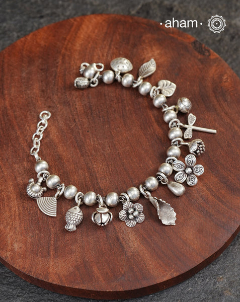 Up your wrist game with the A.M P.M Silver bracelet!
15 beautiful distinct charms all crafted in 92.5 silver come together to make this piece . Whether worn at day or night, this bracelet is Perfect for adding a playful touch to any outfit.