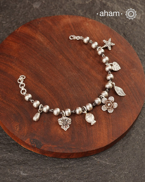 Up your wrist game with the A.M P.M Silver bracelet!
7 beautiful distinct charms all crafted in 92.5 silver come together to make this piece . Whether worn at day or night, this bracelet is Perfect for adding a playful touch to any outfit.

The price is for one piece only.