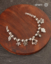 Up your wrist game with the A.M P.M Silver bracelet!
7 beautiful distinct charms all crafted in 92.5 silver come together to make this piece . Whether worn at day or night, this bracelet is Perfect for adding a playful touch to any outfit.

The price is for one piece only.