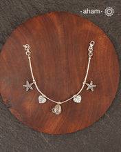 Up your wrist game with the A.M P.M Silver bracelet!
Beautiful distinct charms all crafted in 92.5 silver come together to make this piece. the little bells make a rhythmic sound. Whether worn at day or night, this bracelet is Perfect for adding a playful touch to any outfit.

The price is for one piece only.