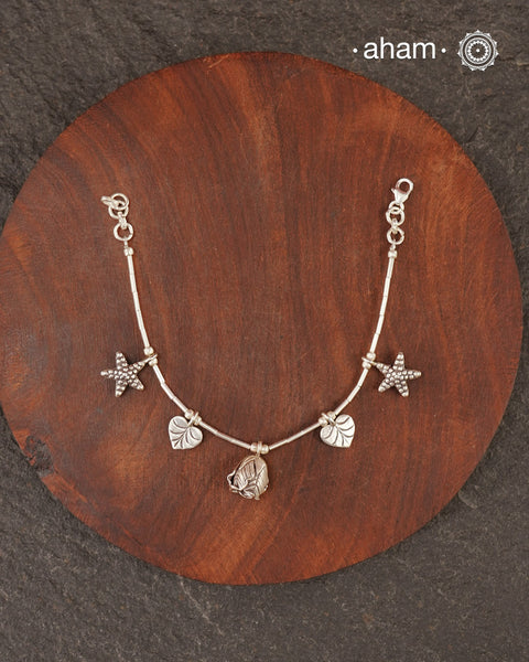 Up your wrist game with the A.M P.M Silver bracelet!
Beautiful distinct charms all crafted in 92.5 silver come together to make this piece. the little bells make a rhythmic sound. Whether worn at day or night, this bracelet is Perfect for adding a playful touch to any outfit.

The price is for one piece only.