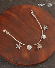 Up your wrist game with the A.M P.M Silver bracelet!
Beautiful distinct charms all crafted in 92.5 silver come together to make this piece. the little bells make a rhythmic sound. Whether worn at day or night, this bracelet is Perfect for adding a playful touch to any outfit.

The price is for one piece only.