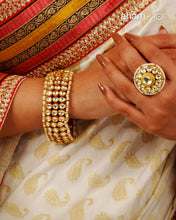 Handcrafted festive silver bracelet with gold polish, kundan work and embellished cultured pearls.