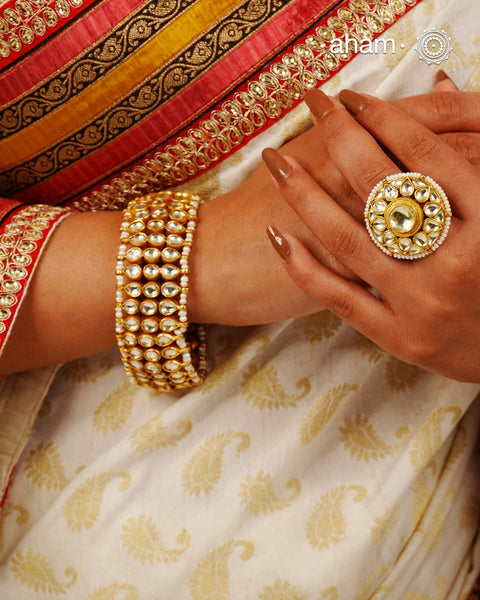 Handcrafted festive silver bracelet with gold polish, kundan work and embellished cultured pearls.