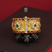 Crafted with expert precision, this Kundan Gold Polish Silver Kada showcases a stunning traditional design, also known as a patla in Gujarati. The kada features intricate Kundan highlights and is made of 92.5 silver with a lustrous gold polish. Perfect for adding a touch of elegance to any outfit. The price is for one piece kada only. 