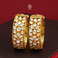 Add an elegant touch to your ethnic ensemble with our Kundan Gold Polish Silver Kada. Crafted in silver with a classic gold polish, these versatile Kadas are a must-have for weddings and special occasions. With the option to wear them alone or stacked, these Kadas are a versatile and timeless accessory.