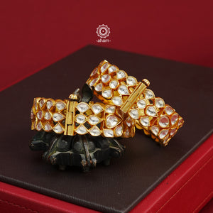 Add an elegant touch to your ethnic ensemble with our Kundan Gold Polish Silver Kada. Crafted in silver with a classic gold polish, these versatile Kadas are a must-have for weddings and special occasions. With the option to wear them alone or stacked, these Kadas are a versatile and timeless accessory. The price is for a set of 2 pieces kada only. 