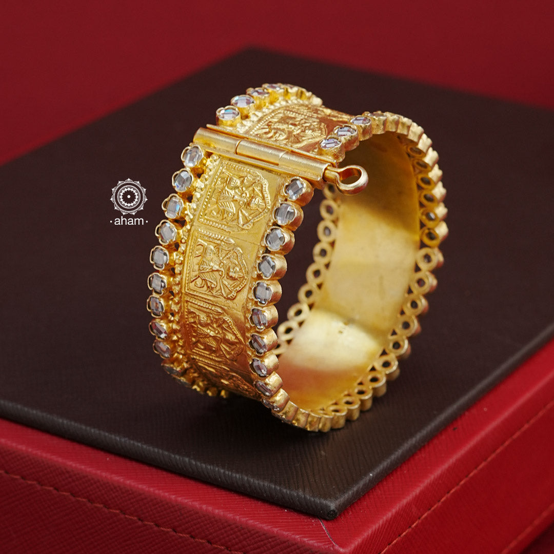 This gold polish silver Kada with zircon stone highlights is a classic and versatile piece, crafted in silver for weddings and special occasions. Its elegant design and openable option make it a must-have accessory. Add a touch of sophistication to any outfit with this timeless Kada. The price is for a One pieces kada only. 