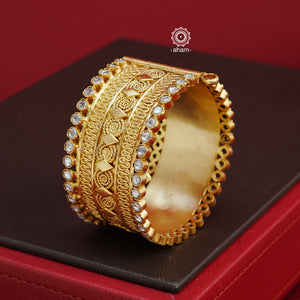 Crafted in 92.5 silver with gold polish, this statement kada features stunning zircon stone highlights. Elegant and eye-catching, this openable kada adds a touch of glamour to any outfit. The price is for a One pieces kada only. 