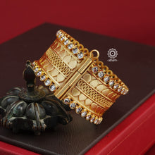 Looking for a gold toned accessory that works for both your Indian and western outfits? Then this is the perfect piece. Crafted in 92.5 silver with gold polish, this versatile kada is a must have addition to your wardrobe.  The price is for a One pieces kada only. 