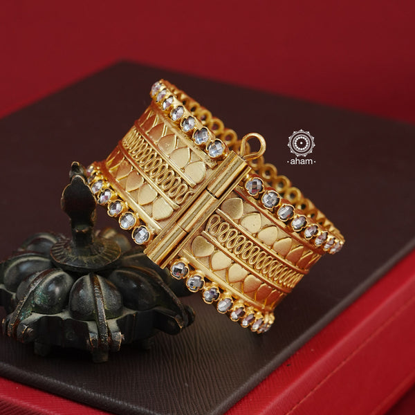 Looking for a gold toned accessory that works for both your Indian and western outfits? Then this is the perfect piece. Crafted in 92.5 silver with gold polish, this versatile kada is a must have addition to your wardrobe.  The price is for a One pieces kada only. 