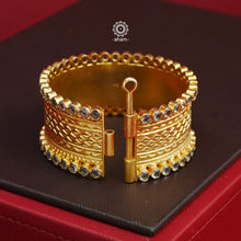 Looking for a gold toned accessory that works for both your Indian and western outfits? Then this is the perfect piece. Crafted in 92.5 silver with gold polish, this versatile kada is a must have addition to your wardrobe.  The price is for a One pieces kada only. 