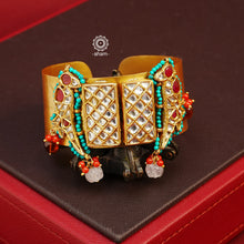 Introducing our Gold Polish Hand Cuff, a contemporary take on the traditional kada design. This beautiful cuff features stunning kundan work and is crafted in silver with a sleek gold polish. Elevate your indo-western outfits with this modern yet elegant accessory.