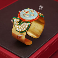 Elevate your jewellery game with our Gold Polish Hand Cuff with Kundan fish motifs. Its striking gold polish enhances the stunning stone inlay center and intricate kundan work. Versatile for both Indo-Western and traditional attire, this open cuff adds a stylish touch to any outfit.