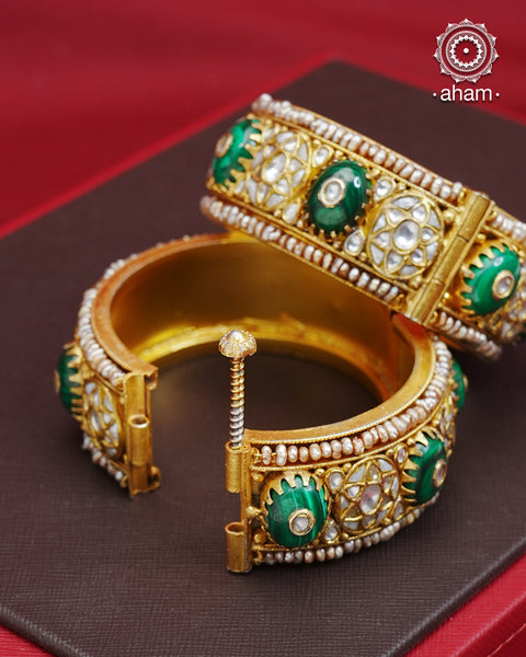 Elevate any outfit with our Kundan Gold Polish Silver Kada. Handcrafted with 92.5 sterling silver, this classic and versatile piece features green stone, mother of pearl, and pearl accents. Perfect for weddings and special occasions. Available in size 2.4 and openable design for easy wear.&nbsp;