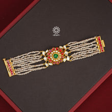 Expertly handcrafted with intricate Kundan work, this sterling silver Bracelet features a stunning gold polish and delicate pearl handwork. Perfect for any festive occasion, it adds a touch of elegance to any outfit. Elevate your style with this beautiful piece.