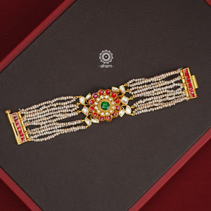 Expertly handcrafted with intricate Kundan work, this sterling silver Bracelet features a stunning gold polish and delicate pearl handwork. Perfect for any festive occasion, it adds a touch of elegance to any outfit. Elevate your style with this beautiful piece.