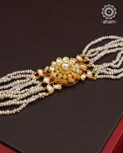 Expertly handcrafted with intricate Kundan work, this sterling silver Bracelet features a stunning gold polish and delicate pearl handwork. Perfect for any festive occasion, it adds a touch of elegance to any outfit. Elevate your style with this beautiful piece.