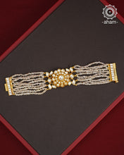 Expertly handcrafted with intricate Kundan work, this sterling silver Bracelet features a stunning gold polish and delicate pearl handwork. Perfect for any festive occasion, it adds a touch of elegance to any outfit. Elevate your style with this beautiful piece.