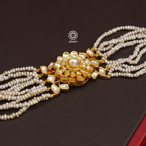 Expertly handcrafted with intricate Kundan work, this sterling silver Bracelet features a stunning gold polish and delicate pearl handwork. Perfect for any festive occasion, it adds a touch of elegance to any outfit. Elevate your style with this beautiful piece.