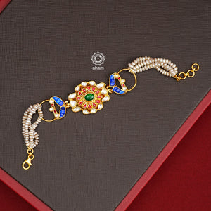 Expertly handcrafted with intricate Kundan work, this sterling silver Bracelet features a stunning gold polish and delicate pearl handwork. Perfect for any festive occasion, it adds a touch of elegance to any outfit. Elevate your style with this beautiful piece.