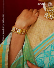 Embrace the allure of timeless elegance with Aham Jewellery’s latest Mother of Pearl collection, a radiant choice for festive celebrations and weddings.

The bracelet is crafted in 92.5 silver and adorned with a luxurious gold polish, capturing the iridescent beauty of mother of pearl.
