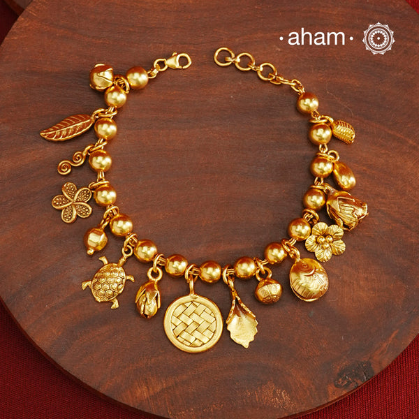 Up your wrist game with the A.M P.M Silver bracelet! 15 beautiful distinct charms all crafted in 92.5 silver with gold polish come together to make this piece. Whether worn at day or night, this bracelet is Perfect for adding a playful touch to any outfit.