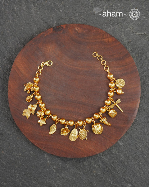 Up your wrist game with the A.M P.M Silver bracelet! 15 beautiful distinct charms all crafted in 92.5 silver with gold polish come together to make this piece.&nbsp;Whether worn at day or night, this bracelet is Perfect for adding a playful touch to any outfit.&nbsp;

The price is for one piece only.