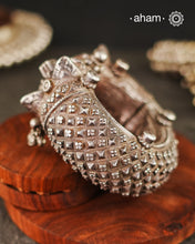 Our collection proudly showcases a rare and exquisite pair of vintage Todo or Kalla anklets, originating from the culturally rich region of Gujarat, India. These anklets transcend mere adornments; they are a testament to the artistry and craftsmanship of generations past. Handcrafted with meticulous precision using solid silver and employing remarkable repousse and chasing techniques, they exemplify the unparalleled skill of artisans who have honed their craft over centuries.
