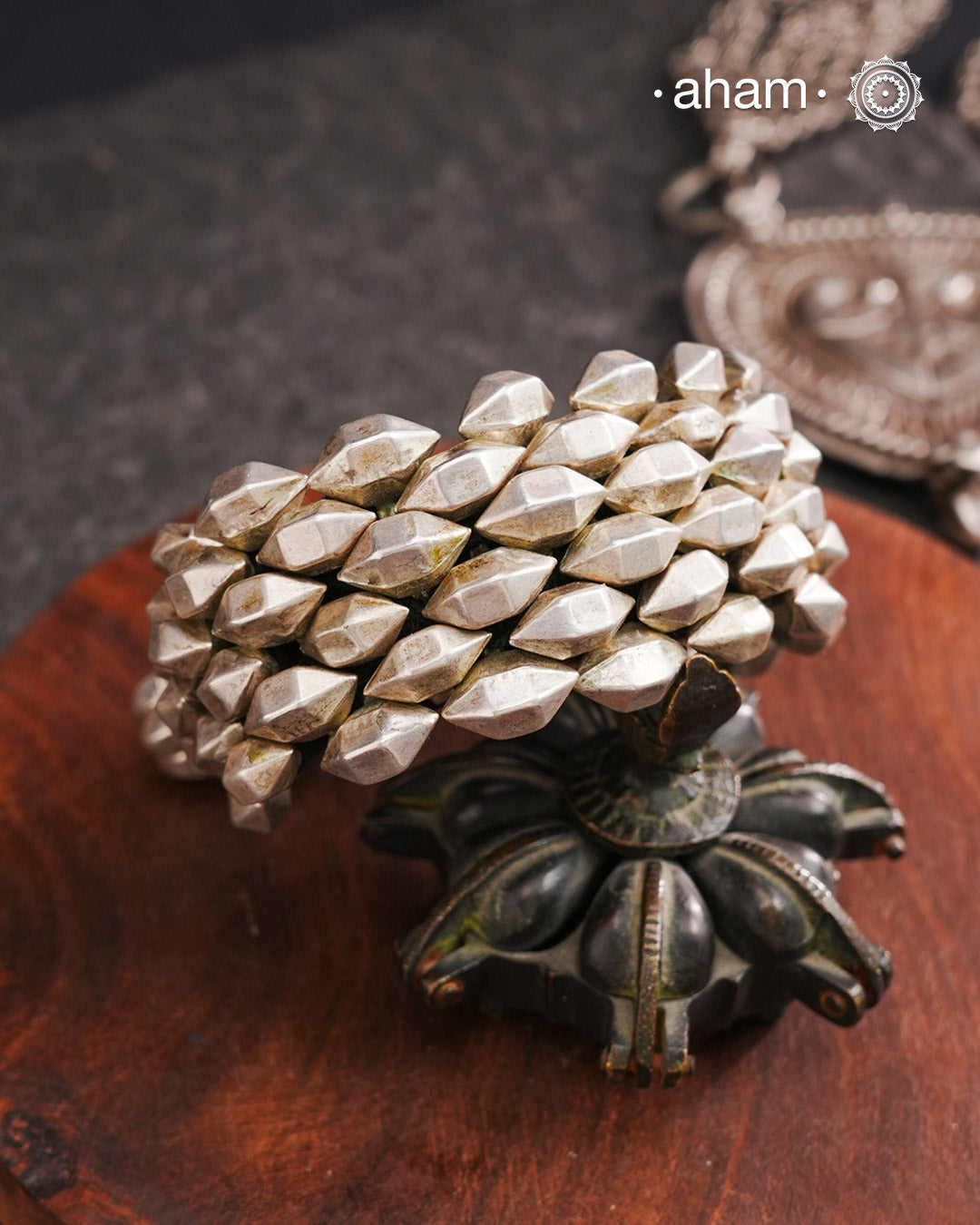 Tribal pauchi with silver bead work, handcrafted by skilful artisans. Also known as lahsan ki Pahunchian, (Each representing a clove of garlic) Many single bead units are closely strung on a black cotoon cord, this piece has 6 parallel rows. closed with end loop and ball.  Beautiful handcuff from a bygone era, that bring back memories and stories of that time