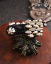 Tribal pauchi with silver bead work, handcrafted by skilful artisans. Also known as lahsan ki Pahunchian, (Each representing a clove of garlic) Many single bead units are closely strung on a black cotoon cord, this piece has 6 parallel rows. closed with end loop and ball.  Beautiful handcuff from a bygone era, that bring back memories and stories of that time