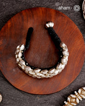 Tribal pauchi with silver bead work, handcrafted by skilful artisans. Also known as lahsan ki Pahunchian, (Each representing a clove of garlic) Many single bead units are closely strung on a black cotoon cord, this piece has 6 parallel rows. closed with end loop and ball.  Beautiful handcuff from a bygone era, that bring back memories and stories of that time