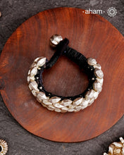 Tribal pauchi with silver bead work, handcrafted by skilful artisans. Also known as lahsan ki Pahunchian, (Each representing a clove of garlic) Many single bead units are closely strung on a black cotoon cord, this piece has 6 parallel rows. closed with end loop and ball.  Beautiful handcuff from a bygone era, that bring back memories and stories of that time