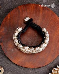 Tribal pauchi with silver bead work, handcrafted by skilful artisans. Also known as lahsan ki Pahunchian, (Each representing a clove of garlic) Many single bead units are closely strung on a black cotoon cord, this piece has 6 parallel rows. closed with end loop and ball.  Beautiful handcuff from a bygone era, that bring back memories and stories of that time