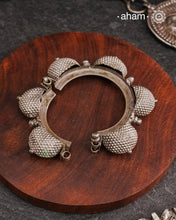 Vintage silver kada with intricate work, handcrafted by skilful artisans. Beautiful piece from a bygone era, that bring back memories and stories of that time. The Naugari Kada is a Two part bracelet with projected simulated gajre balls made from stamped silver sheet.