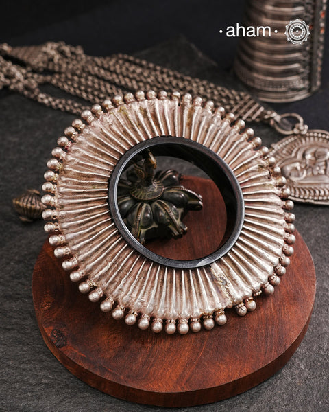 Vintage Silver Kada from Rajasthan. Beautiful piece from a bygone era, that bring back memories and stories of that time. Comes with a plastic bangle inside. Super light. Works great for stacking. Originally a arm piece.it is the bangle in the front that the model is wearing in the image.the samller of the two kadas