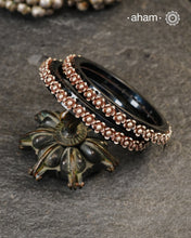 Beautiful tribal silver Bangles. Perfectly crafted silver flowers set on Black plastic bangles. Comes as a set of 2 Bangles