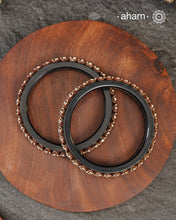 Beautiful tribal silver Bangles. Perfectly crafted silver flowers set on Black plastic bangles. Comes as a set of 2 Bangles