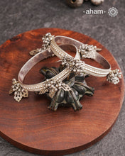 Celebrate Navratri with these expertly crafted tribal silver bangles, featuring delicate trinklets that add a rhythmic charm to your traditional attire. They offer a comfortable fit while enhancing your festive look with authentic tribal elegance. Perfect for those who appreciate handcrafted silver jewellery with cultural significance.