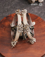 Celebrate Navratri with these expertly crafted tribal silver bangles, featuring delicate trinklets that add a rhythmic charm to your traditional attire. They offer a comfortable fit while enhancing your festive look with authentic tribal elegance. Perfect for those who appreciate handcrafted silver jewellery with cultural significance.