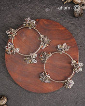 Celebrate Navratri with these expertly crafted tribal silver bangles, featuring delicate trinklets that add a rhythmic charm to your traditional attire. They offer a comfortable fit while enhancing your festive look with authentic tribal elegance. Perfect for those who appreciate handcrafted silver jewellery with cultural significance.
