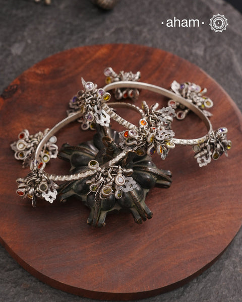 Celebrate Navratri with these expertly crafted tribal silver bangles, featuring delicate trinklets that add a rhythmic charm to your traditional attire. They offer a comfortable fit while enhancing your festive look with authentic tribal elegance. Perfect for those who appreciate handcrafted silver jewellery with cultural significance.