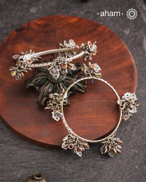 Celebrate Navratri with these expertly crafted tribal silver bangles, featuring delicate trinklets that add a rhythmic charm to your traditional attire. They offer a comfortable fit while enhancing your festive look with authentic tribal elegance. Perfect for those who appreciate handcrafted silver jewellery with cultural significance.