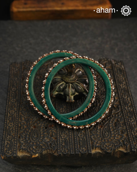 Beautiful tribal silver Bangles. Perfectly crafted silver flowers set on green plastic bangles. Comes as a set of 2 Bangles.AVAILABLE ON PREORDER BASIS