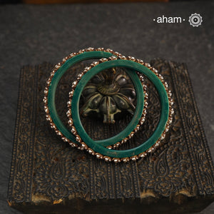 Beautiful tribal silver Bangles. Perfectly crafted silver flowers set on green plastic bangles. Comes as a set of 2 Bangles.AVAILABLE ON PREORDER BASIS