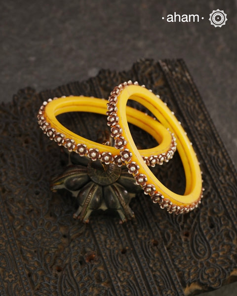 Beautiful tribal silver Bangles. Perfectly crafted silver flowers set on yellow plastic bangles. 